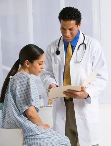 Doctor showing report to patient